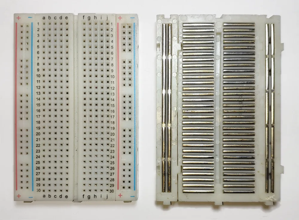 A solderless breadboard, top and bottom view